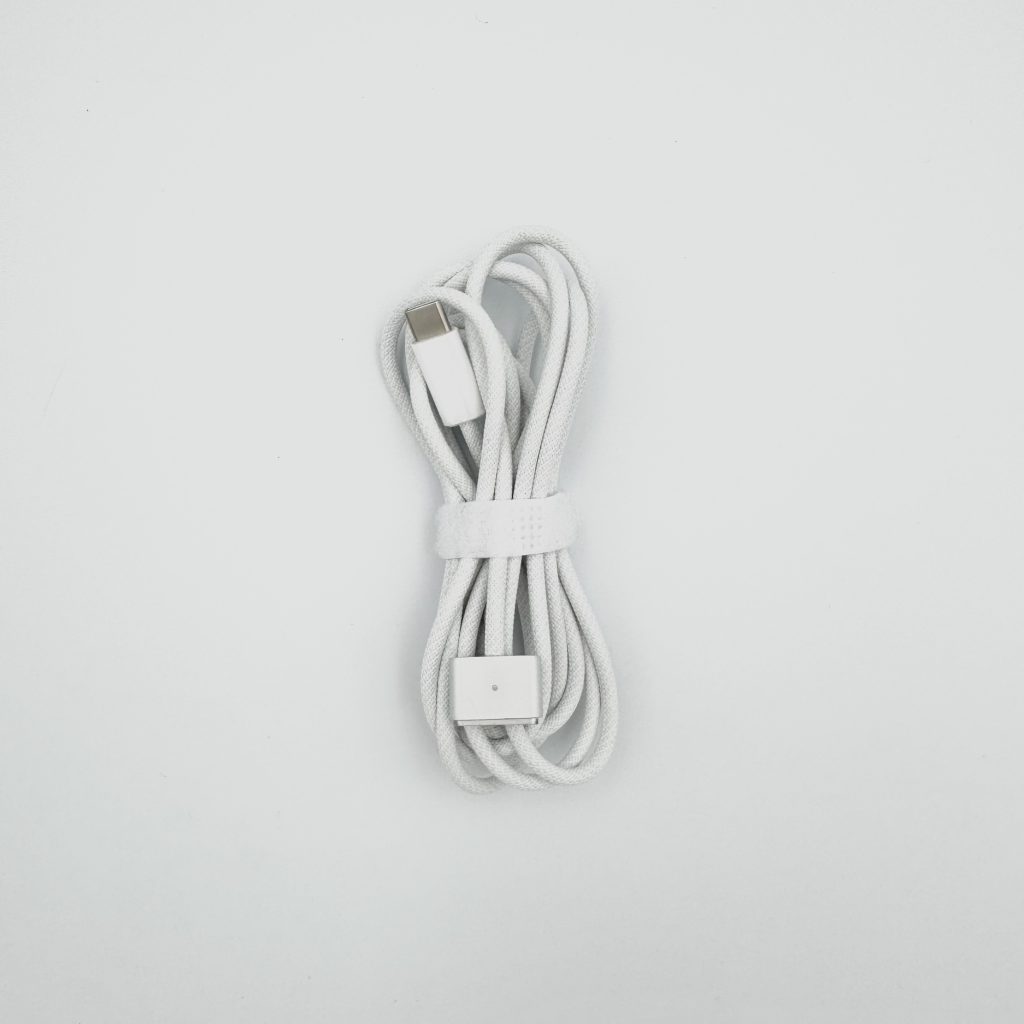 White braided Magsafe 3 charging cable for MacBook with USB-C, photo taken in Tbilisi, Georgia