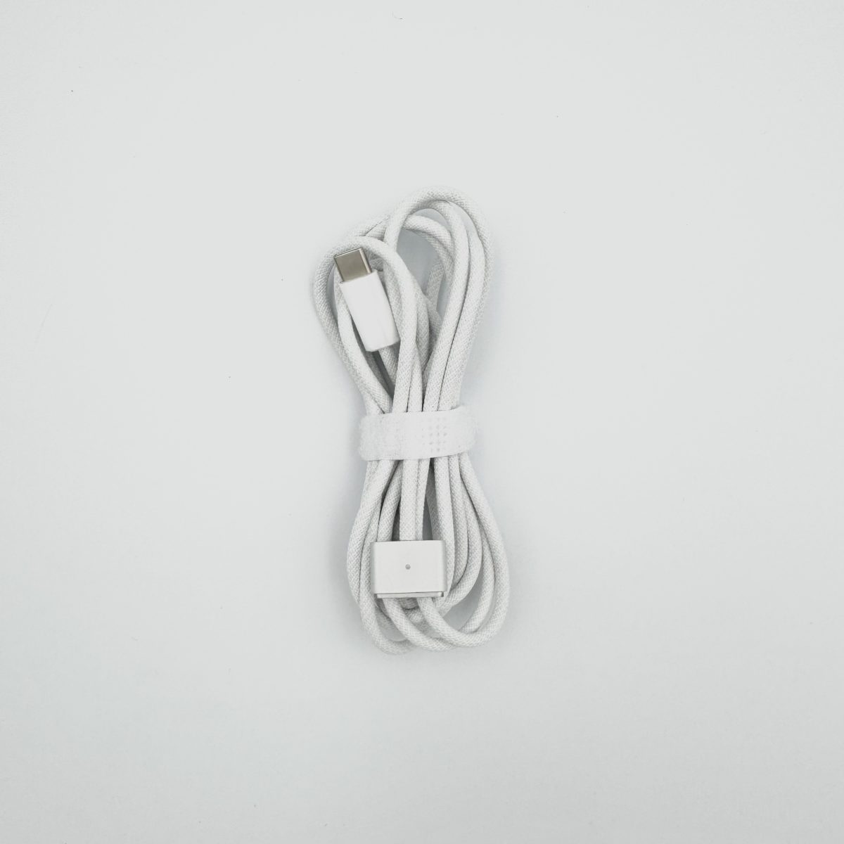 White braided Magsafe 3 charging cable for MacBook with USB-C, photo taken in Tbilisi, Georgia