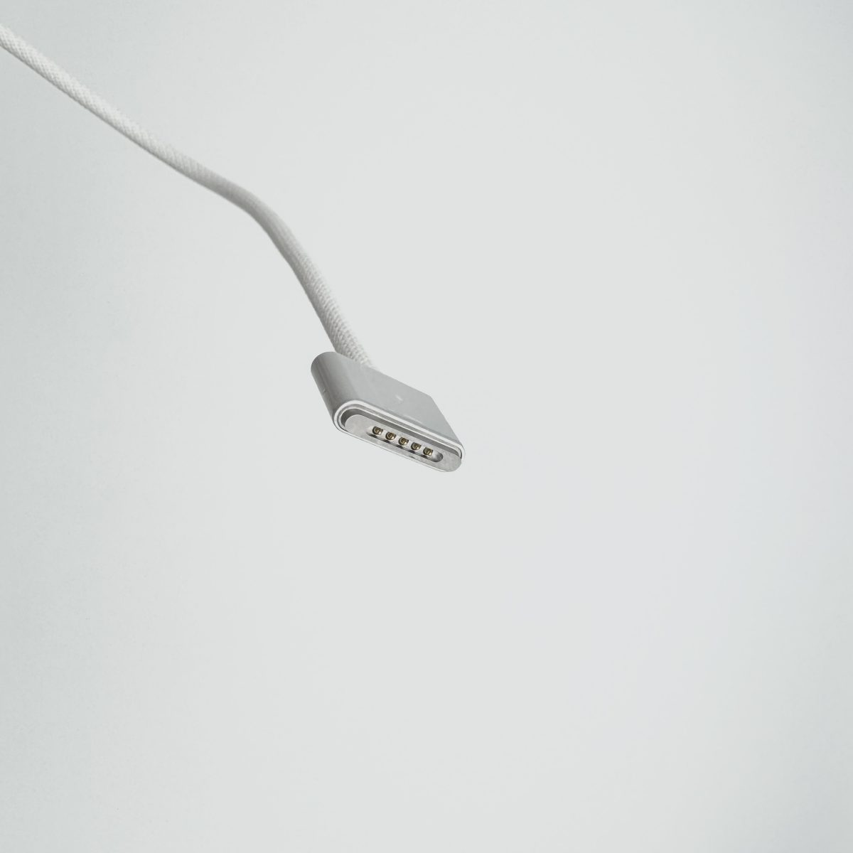 Close-up of Magsafe 3 cable connector for MacBook, silver color