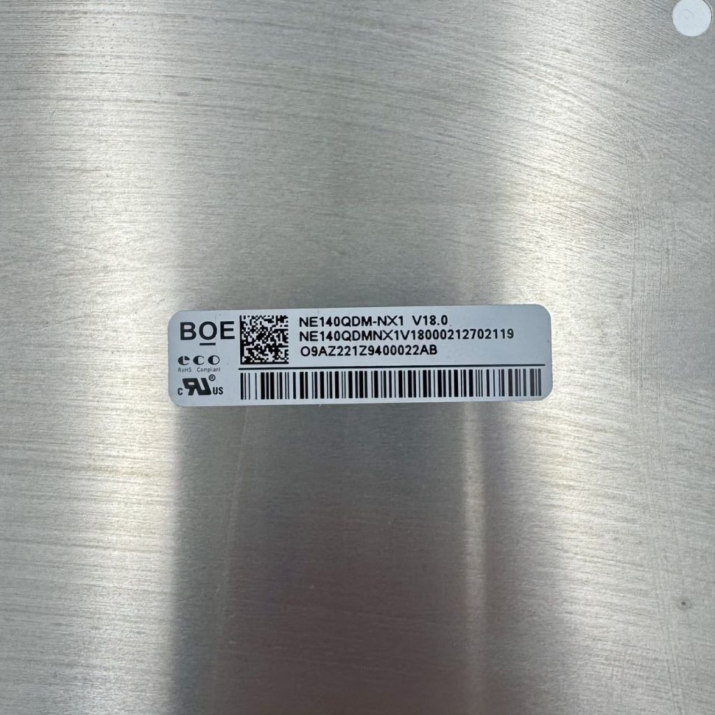 Close-up of NE140QDM-NX1 model label and part number