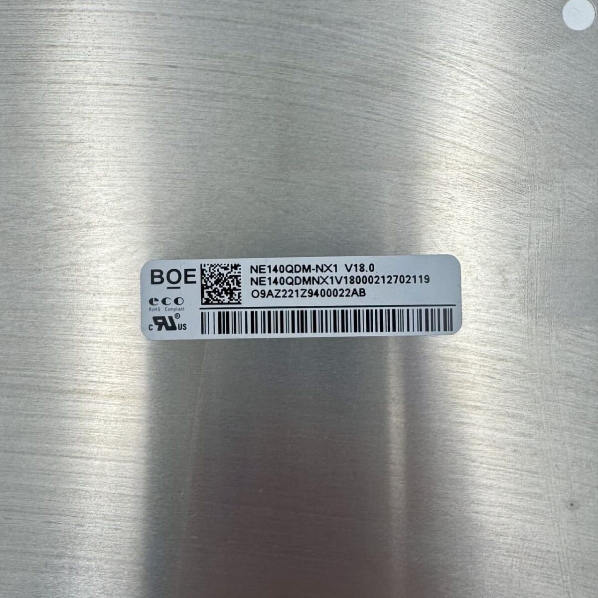 Close-up of NE140QDM-NX1 model label and part number